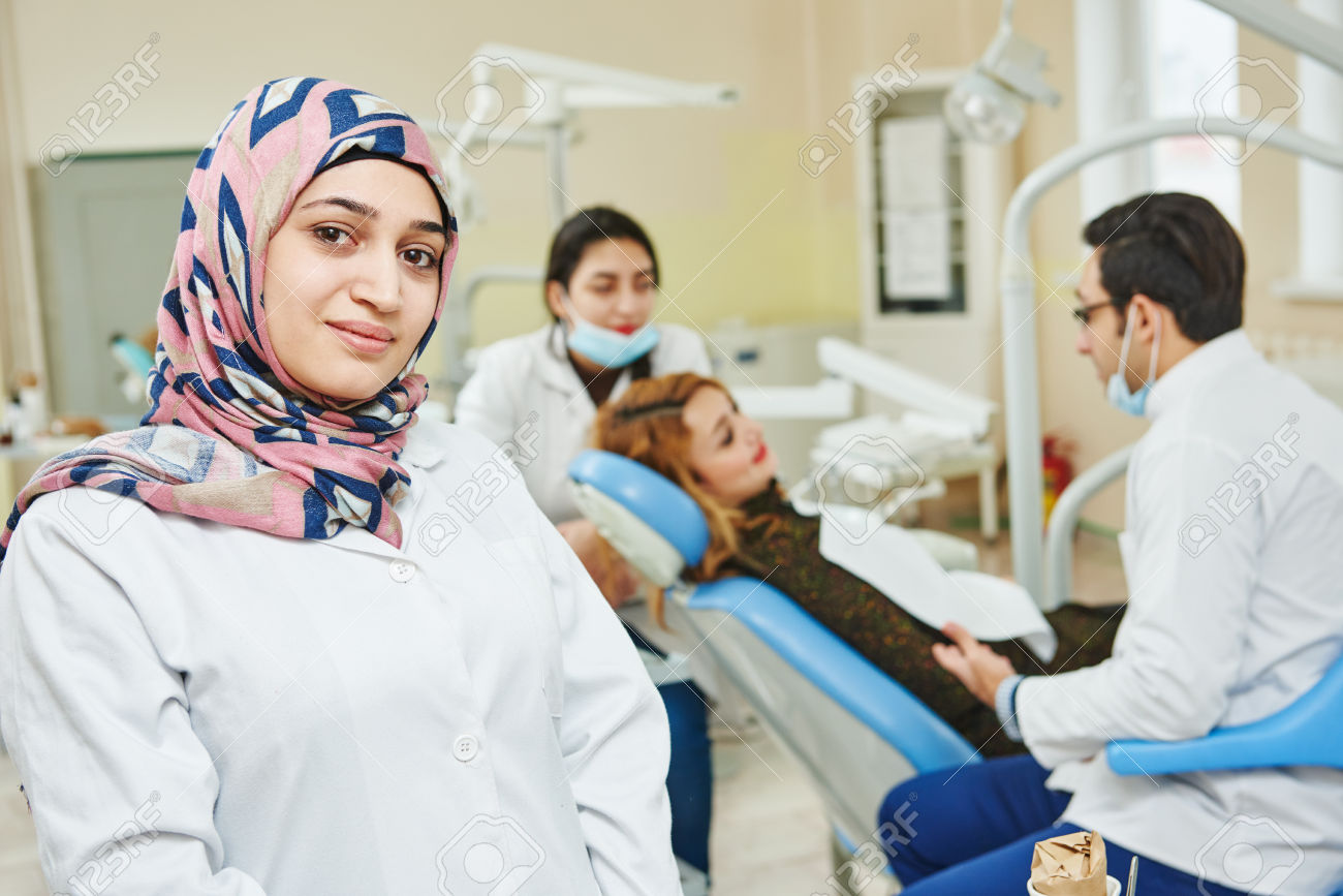 38347398-A-portrait-of-a-iranian-muslim-female-dental-assistant-or-doctor-smiling-the-dentist-working-in-the--Stock-Photo